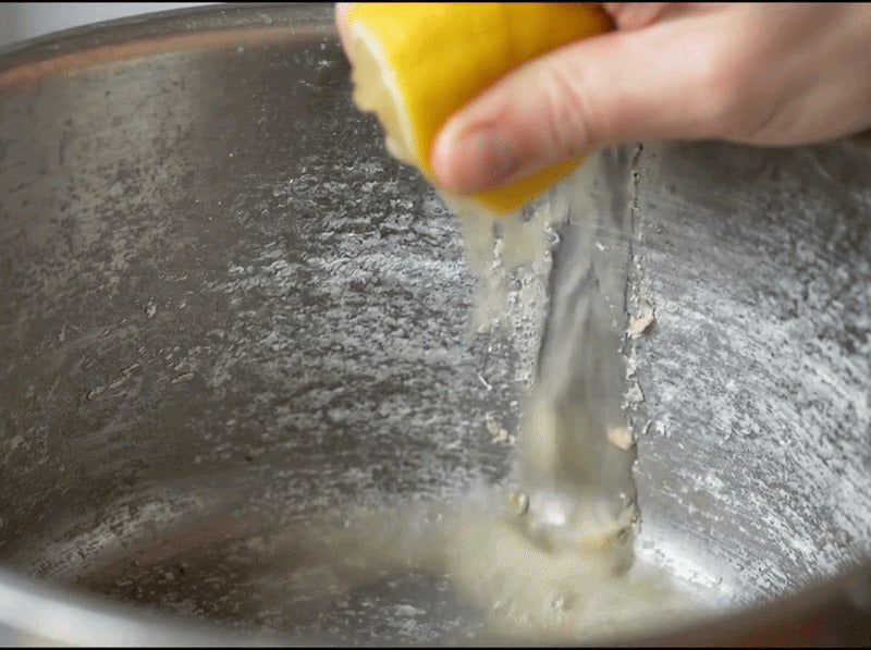 Lemon juice squeezed onto a chalky ring inside a pot