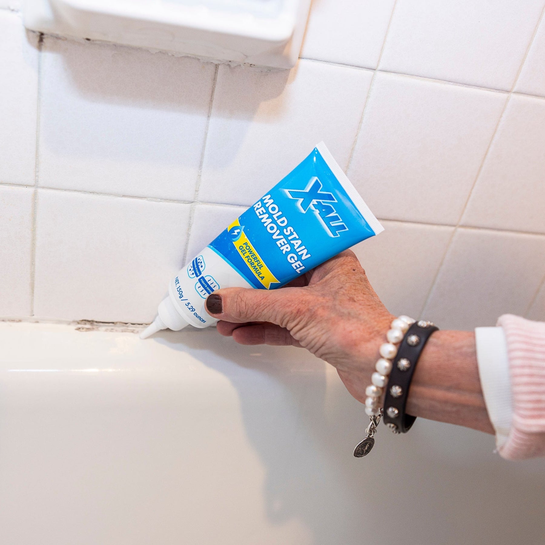Mold Stain Remover Gel being applied along a bathroom caulk line