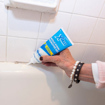 Mold Stain Remover Gel being applied along a bathroom caulk line