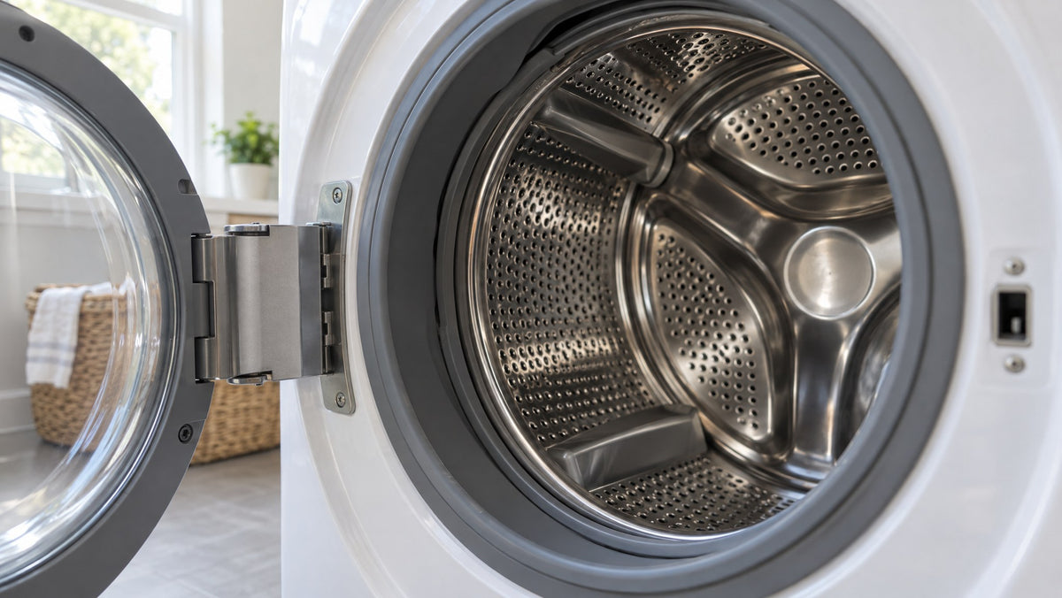 Open front-loading washer with a shiny stainless steel drum that looks clean
