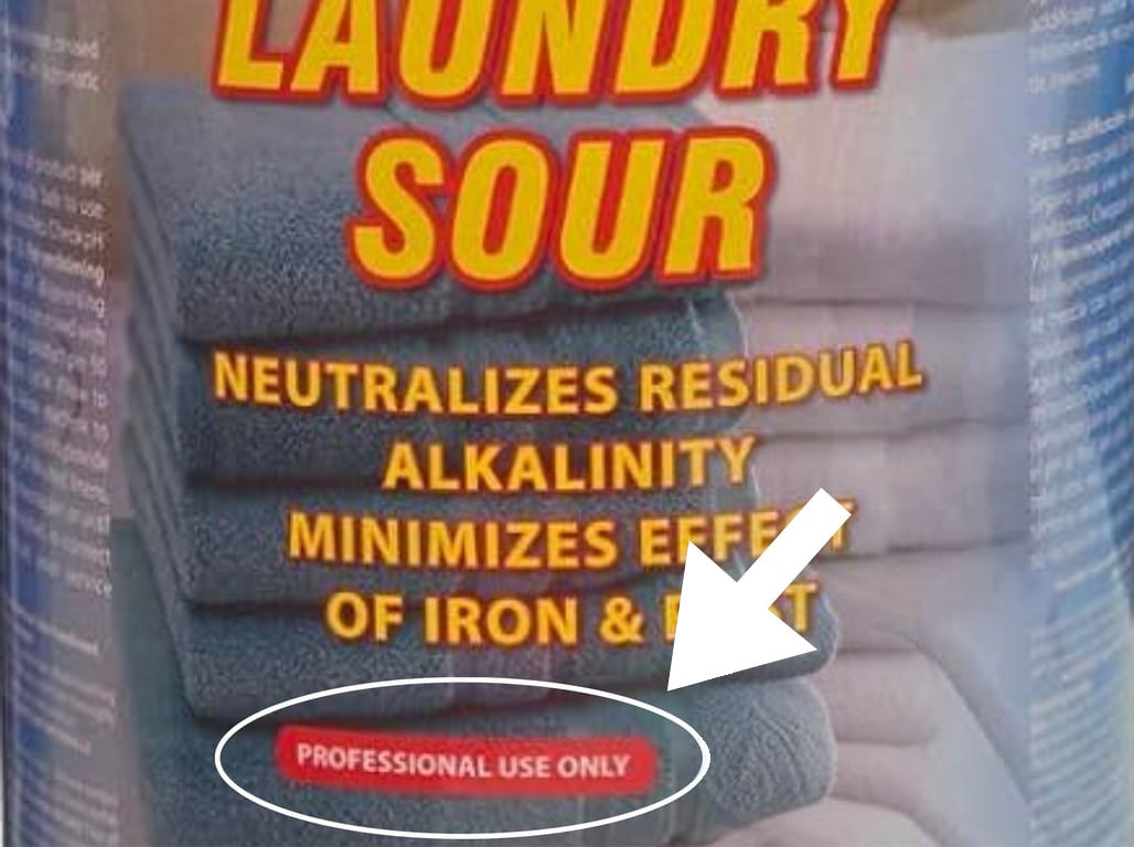 A commercial laundry sour jug labeled for professional use only