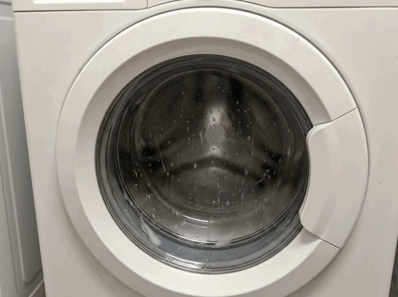 A front-loading washer running a cycle with the door closed